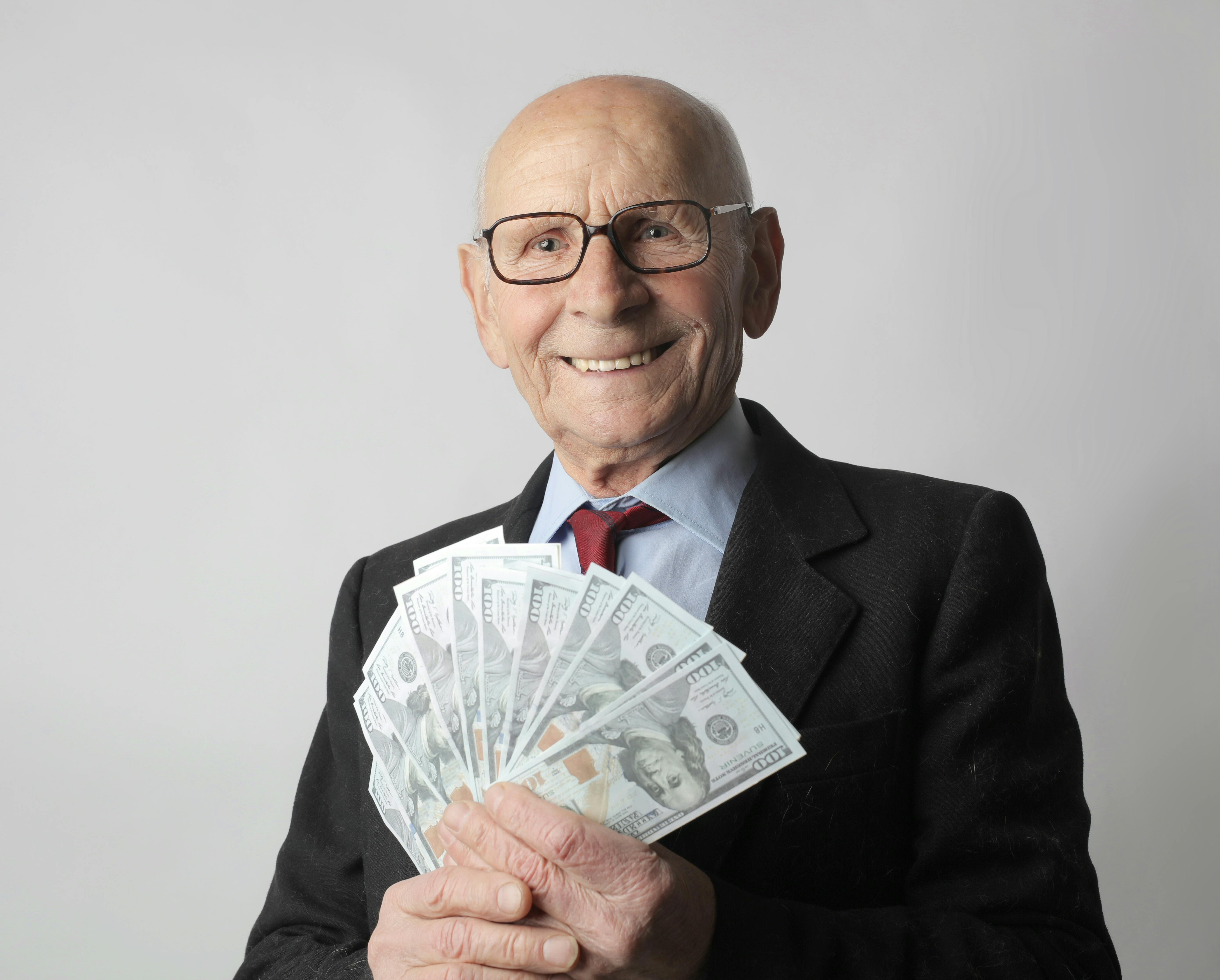 Person%20In%20Black%20Suit%20Holding%20Dollar%20Bills